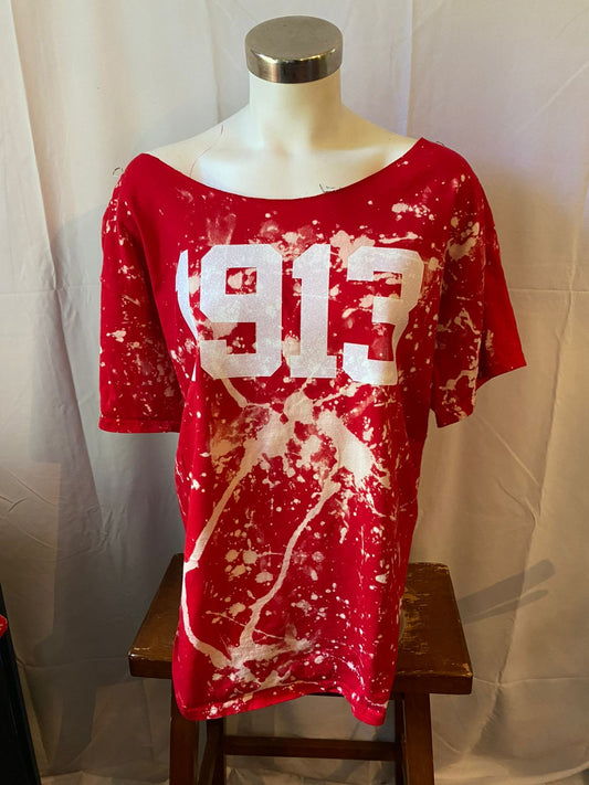 Red t-shirt with white splatter design and '913' printed on a mannequin against a white background